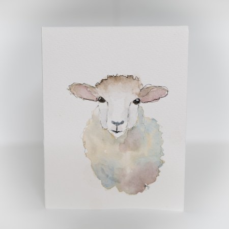 A greeting card featuring a painting of a sheep.