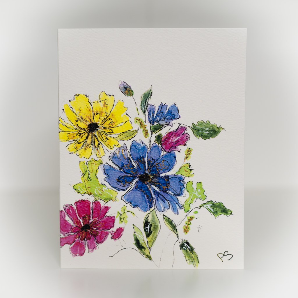 A greeting card featuring a painting of flowers with gold accents.