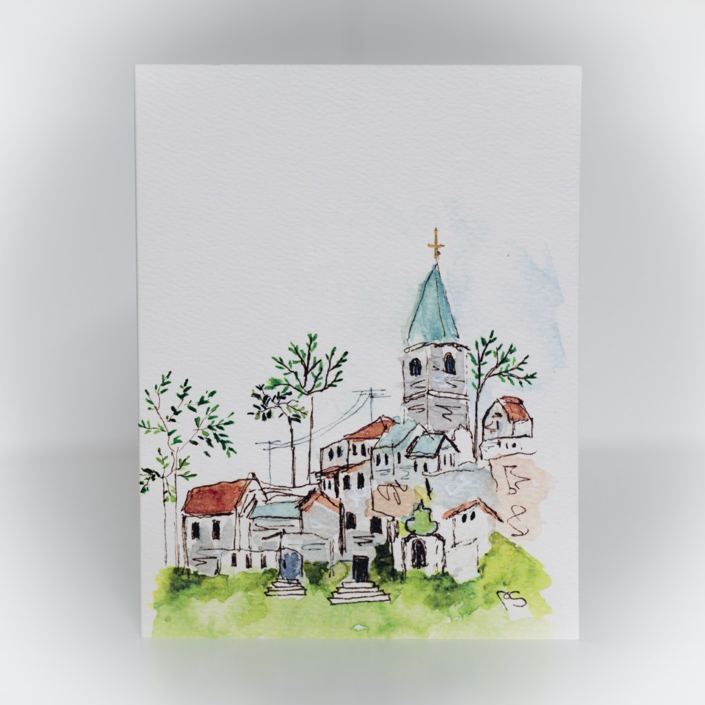 A greeting card featuring a painting of a village with a tall church tower.