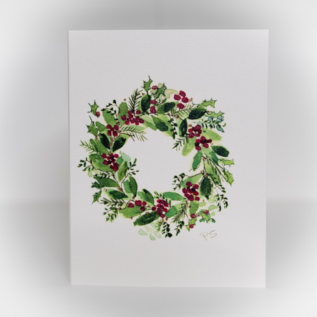 A greeting card featuring a painting of a wreath.